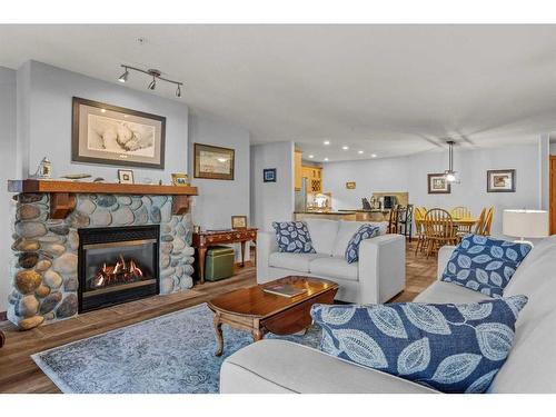 202-150 Crossbow Place, Canmore, AB - Indoor Photo Showing Living Room With Fireplace