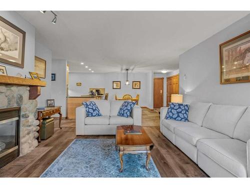 202-150 Crossbow Place, Canmore, AB - Indoor Photo Showing Living Room With Fireplace