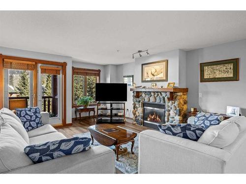 202-150 Crossbow Place, Canmore, AB - Indoor Photo Showing Living Room With Fireplace