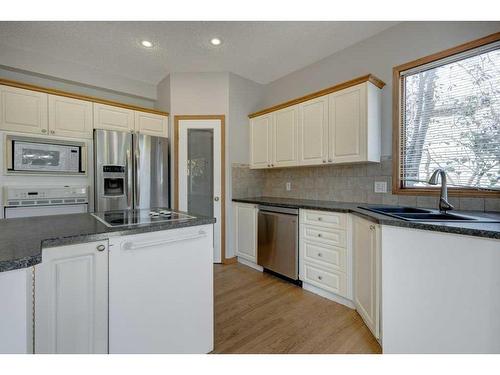 218 Mt Cascade Place Se, Calgary, AB - Indoor Photo Showing Kitchen With Double Sink