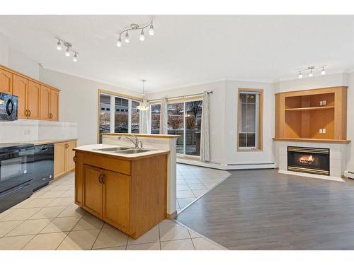 101-108 Edgeridge Terrace Nw, Calgary, AB - Indoor Photo Showing Kitchen With Fireplace With Double Sink