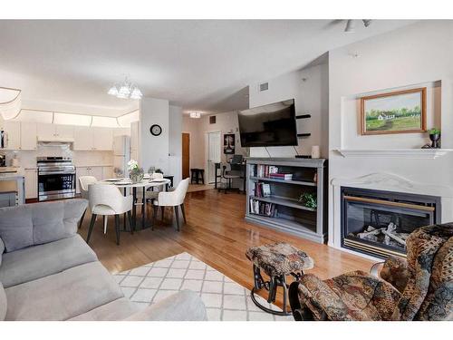 327-728 Country Hills Road Nw, Calgary, AB - Indoor Photo Showing Living Room With Fireplace