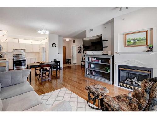 327-728 Country Hills Road Nw, Calgary, AB - Indoor Photo Showing Living Room With Fireplace