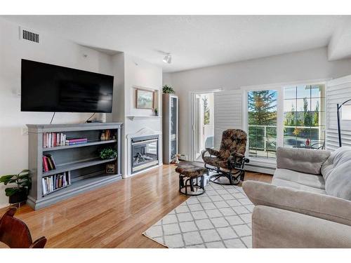 327-728 Country Hills Road Nw, Calgary, AB - Indoor Photo Showing Living Room With Fireplace