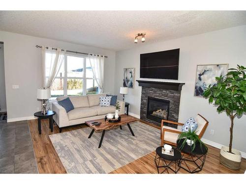 431 Hillcrest Circle Sw, Airdrie, AB - Indoor Photo Showing Living Room With Fireplace