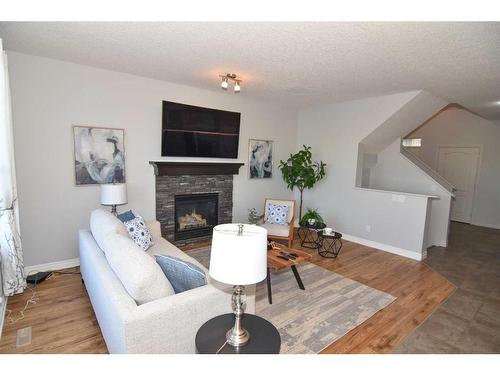 431 Hillcrest Circle Sw, Airdrie, AB - Indoor Photo Showing Living Room With Fireplace