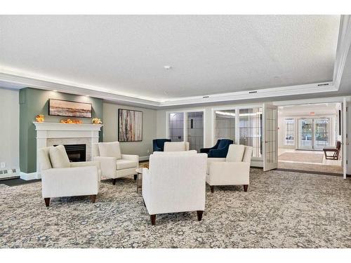 322-2144 Paliswood Road Sw, Calgary, AB - Indoor Photo Showing Living Room With Fireplace