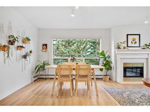 322-2144 Paliswood Road Sw, Calgary, AB - Indoor Photo Showing Living Room With Fireplace