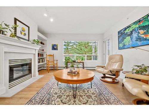 322-2144 Paliswood Road Sw, Calgary, AB - Indoor Photo Showing Living Room With Fireplace