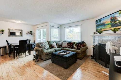 93-200 Shawnessy Drive Sw, Calgary, AB - Indoor Photo Showing Living Room With Fireplace