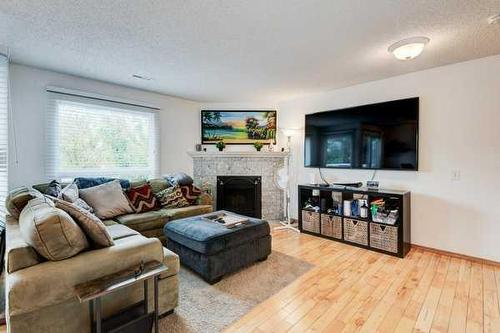 93-200 Shawnessy Drive Sw, Calgary, AB - Indoor Photo Showing Living Room With Fireplace