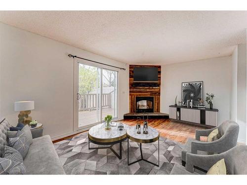 216-15403 Deer Run Drive Se, Calgary, AB - Indoor Photo Showing Living Room With Fireplace