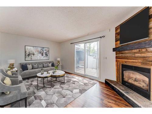 216-15403 Deer Run Drive Se, Calgary, AB - Indoor Photo Showing Living Room With Fireplace