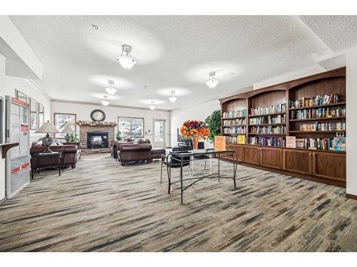 #216-72 Quigley Drive, Cochrane, AB - Indoor With Fireplace