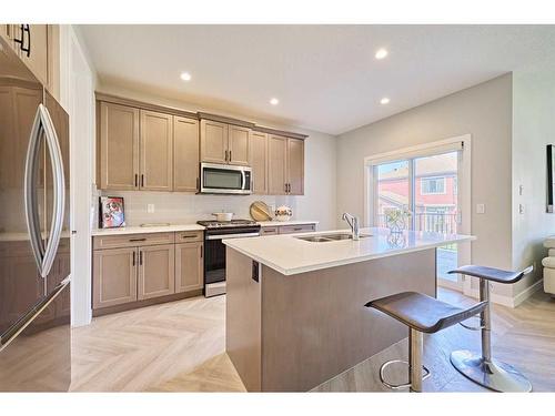 48 Shawnee Green Sw, Calgary, AB - Indoor Photo Showing Kitchen With Stainless Steel Kitchen With Double Sink With Upgraded Kitchen