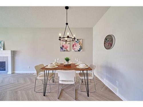 48 Shawnee Green Sw, Calgary, AB - Indoor Photo Showing Dining Room With Fireplace