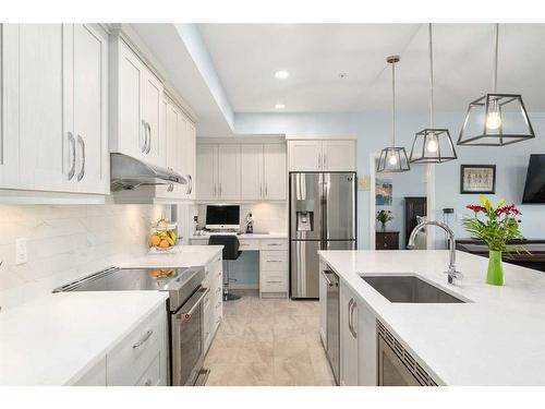 105-4250 Seton Drive Se, Calgary, AB - Indoor Photo Showing Kitchen With Stainless Steel Kitchen With Upgraded Kitchen