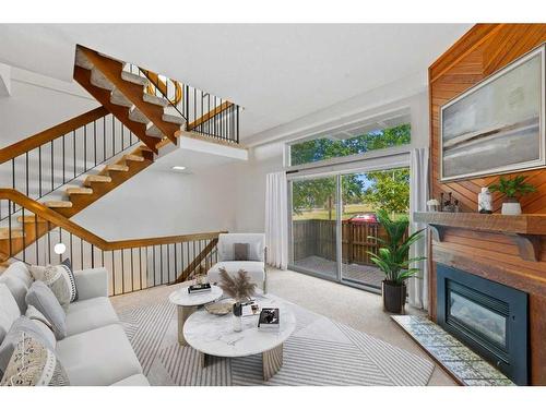 419-3131 63 Avenue Sw, Calgary, AB - Indoor Photo Showing Living Room With Fireplace