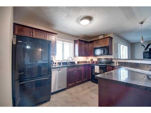 7413-304 Mackenzie Way Sw, Airdrie, AB - Indoor Photo Showing Kitchen