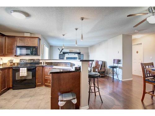 7413-304 Mackenzie Way Sw, Airdrie, AB - Indoor Photo Showing Kitchen