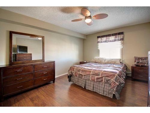 7413-304 Mackenzie Way Sw, Airdrie, AB - Indoor Photo Showing Bedroom