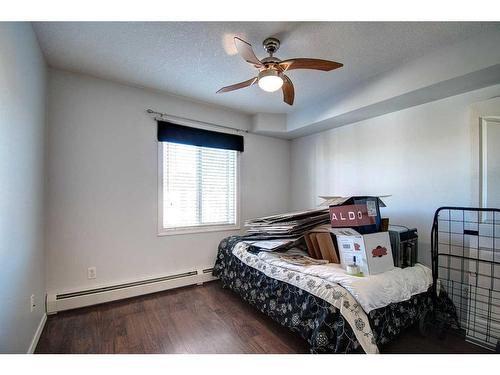 7413-304 Mackenzie Way Sw, Airdrie, AB - Indoor Photo Showing Bedroom