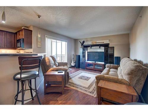 7413-304 Mackenzie Way Sw, Airdrie, AB - Indoor Photo Showing Living Room