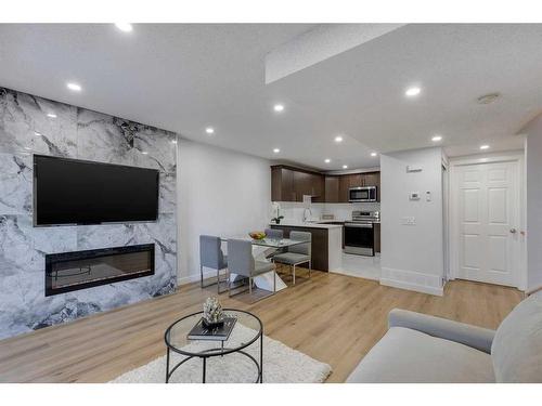 79-3745 Fonda Way Se, Calgary, AB - Indoor Photo Showing Living Room With Fireplace