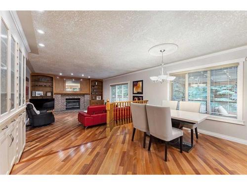 143 Christie Knoll Heights Sw, Calgary, AB - Indoor Photo Showing Dining Room With Fireplace