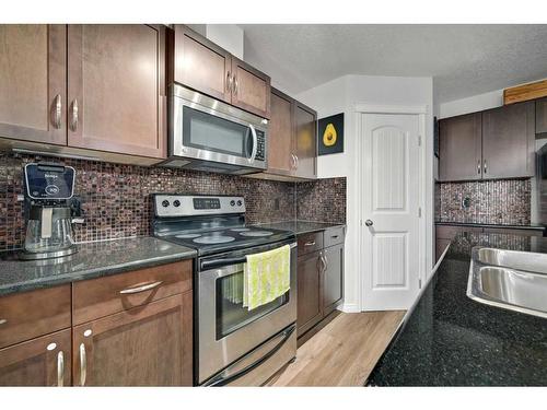 131 Prestwick Villas Se, Calgary, AB - Indoor Photo Showing Kitchen With Stainless Steel Kitchen With Double Sink With Upgraded Kitchen