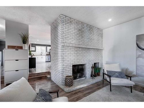 11 Alcock Close, Okotoks, AB - Indoor Photo Showing Living Room With Fireplace