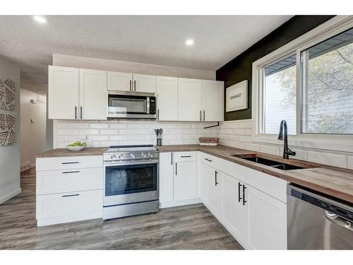 11 Alcock Close, Okotoks, AB - Indoor Photo Showing Kitchen With Double Sink With Upgraded Kitchen