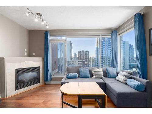 2301-910 5 Avenue Sw, Calgary, AB - Indoor Photo Showing Living Room With Fireplace