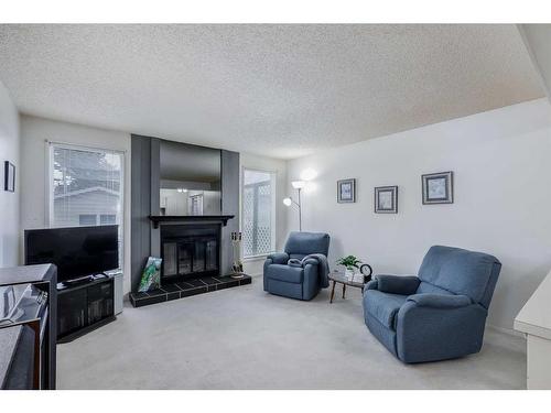 16 Woodmont Green Sw, Calgary, AB - Indoor Photo Showing Living Room With Fireplace