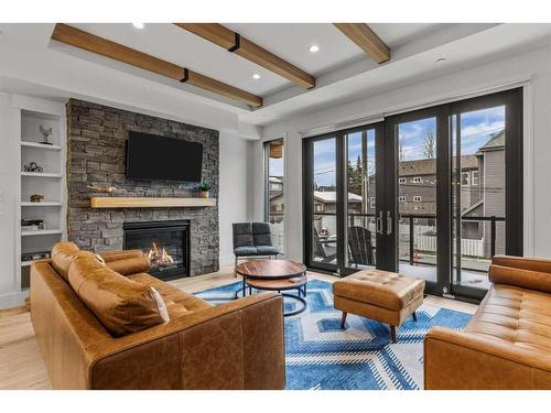 2-802 5 Th Street, Canmore, AB - Indoor Photo Showing Living Room With Fireplace