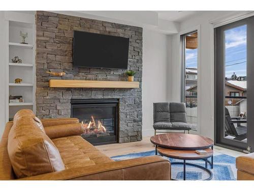 2-802 5 Th Street, Canmore, AB - Indoor Photo Showing Living Room With Fireplace