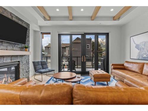 2-802 5 Th Street, Canmore, AB - Indoor Photo Showing Living Room With Fireplace