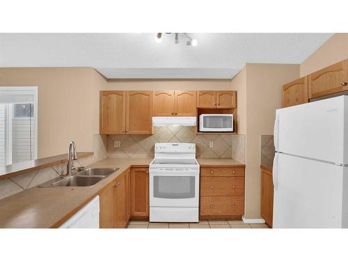 40 Saddlefield Road Ne, Calgary, AB - Indoor Photo Showing Kitchen With Double Sink