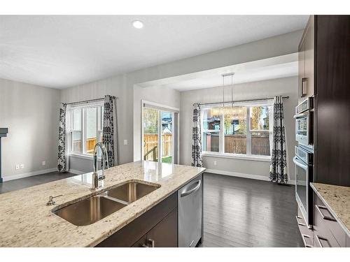 90 Sage Meadows Way Nw, Calgary, AB - Indoor Photo Showing Kitchen With Fireplace With Double Sink