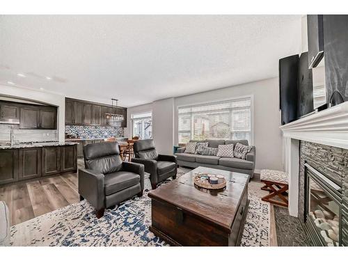 136 Saddlecrest Green Ne, Calgary, AB - Indoor Photo Showing Living Room With Fireplace