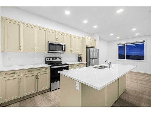 184 Belmont Way Sw, Calgary, AB - Indoor Photo Showing Kitchen With Stainless Steel Kitchen With Double Sink With Upgraded Kitchen