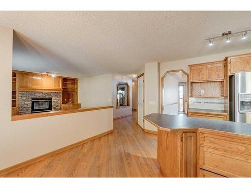 348 Sienna Park Drive Sw, Calgary, AB - Indoor Photo Showing Kitchen With Fireplace