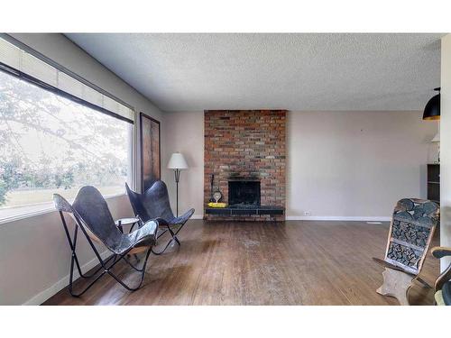 7323 Hunterview Drive Nw, Calgary, AB - Indoor Photo Showing Living Room With Fireplace