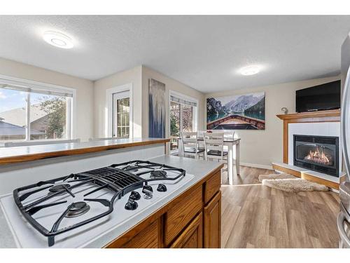 107 Tuffy'S Haven, Strathmore, AB - Indoor Photo Showing Kitchen With Fireplace