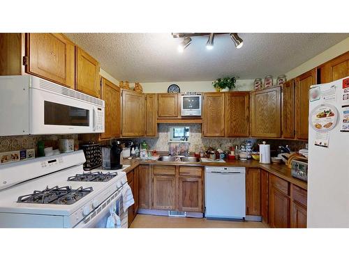 103 Slade Drive, Nanton, AB - Indoor Photo Showing Kitchen With Double Sink