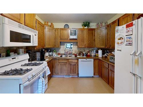 103 Slade Drive, Nanton, AB - Indoor Photo Showing Kitchen With Double Sink