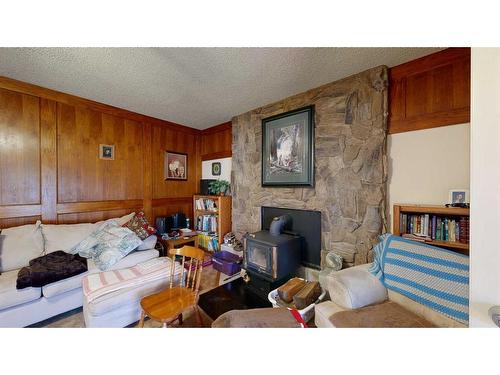 103 Slade Drive, Nanton, AB - Indoor Photo Showing Living Room With Fireplace