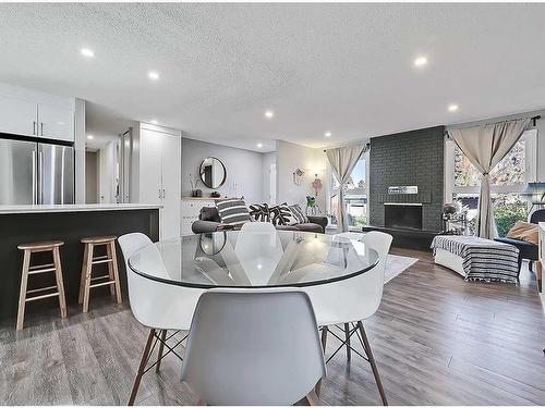 427 Cedarpark Drive Sw, Calgary, AB - Indoor Photo Showing Dining Room With Fireplace