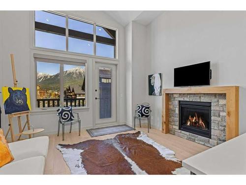 306-1315 Spring Creek Gate, Canmore, AB - Indoor Photo Showing Living Room With Fireplace