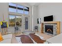 306-1315 Spring Creek Gate, Canmore, AB  - Indoor Photo Showing Living Room With Fireplace 